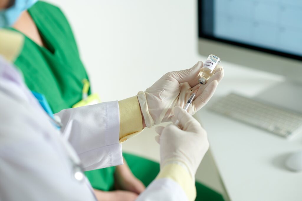 Doctor Filling Syringe with Vaccine